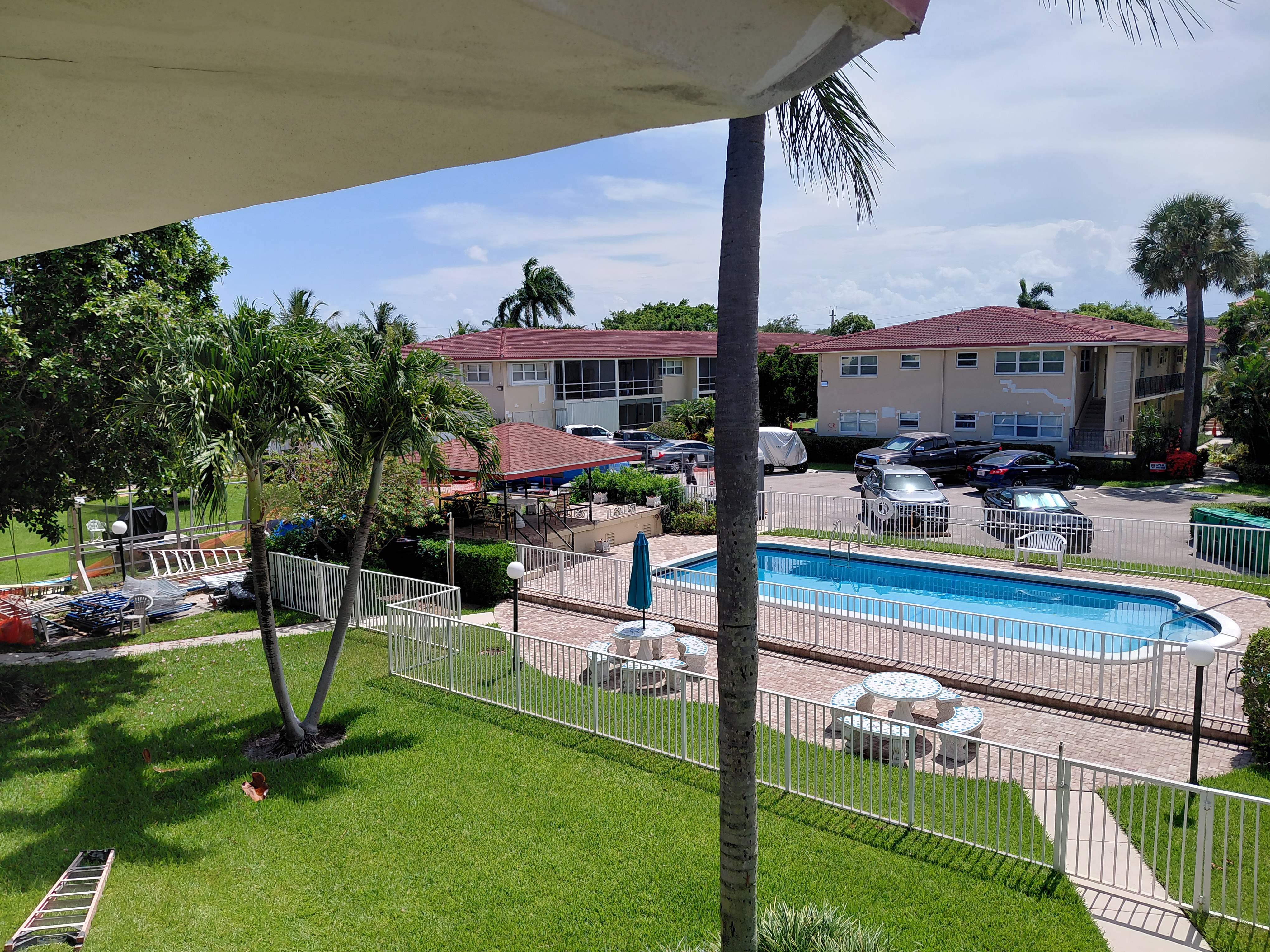 Condo exterior painting near a pool area by Watsons Painting & Drywall Repairs in South Florida